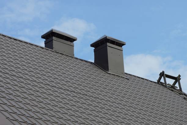 istock two black metal chimneys on a gray tiled roof 1339100454