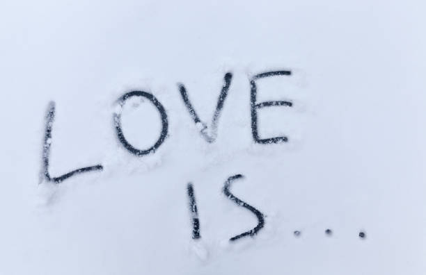 painted on the snow in winter, the word love, in nature drawings on the snow about love