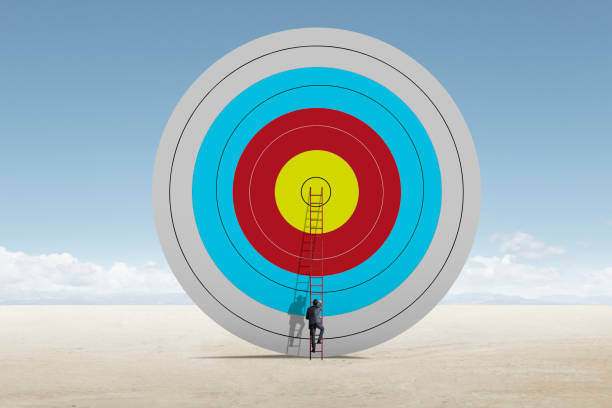 istock Man Uses Ladder To Scale A Large Target 1339102038
