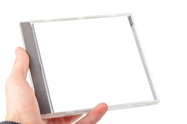 Man holding an empty blank CD or DVD disc box container in hand isolated on white background, cut out. Place for own music album cover picture, simple creative cover image placeholder template, mockup Man holding an empty blank CD or DVD disc box container in hand isolated on white background, cut out. Place for own music album cover picture, simple creative cover image placeholder template, mockup compact disc stock pictures, royalty-free photos & images