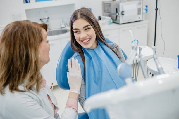 istock Female dentist talking with patient 1339107019