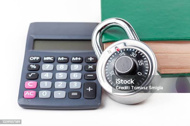 Simple Calculator Coded Padlock And A Closed Book Math Textbook On The Table Cryptography Study Class Course Studying Cryptology Data Encryption Cipher Mathematics Abstract Concept Nobody Stock Photo - Download Image Now