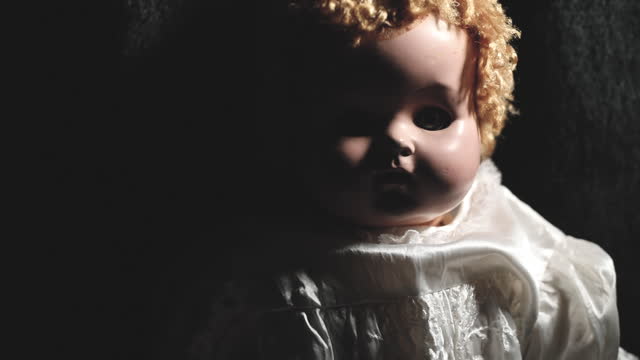 Spooky Vintage Baby Doll in the Shadows