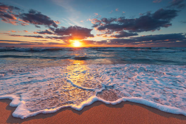 istock Ocean beach sunrise and dramatic clouds over the sea sand 1339111525