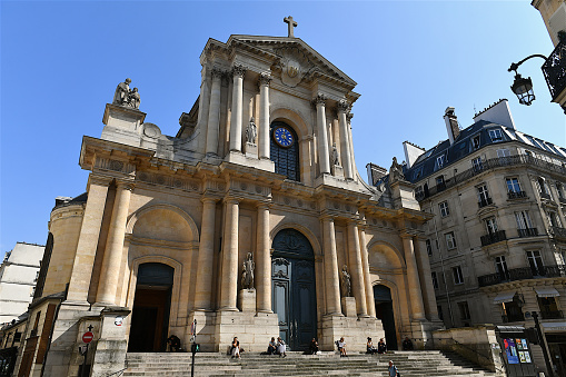 Paris, France-09 03 2021:People seated on the steps of the Saint-Roch church in Paris.The Church of Saint-Roch was built between 1653 and 1740 and is located at 284 rue Saint-Honoré, in the 1st arrondissement.