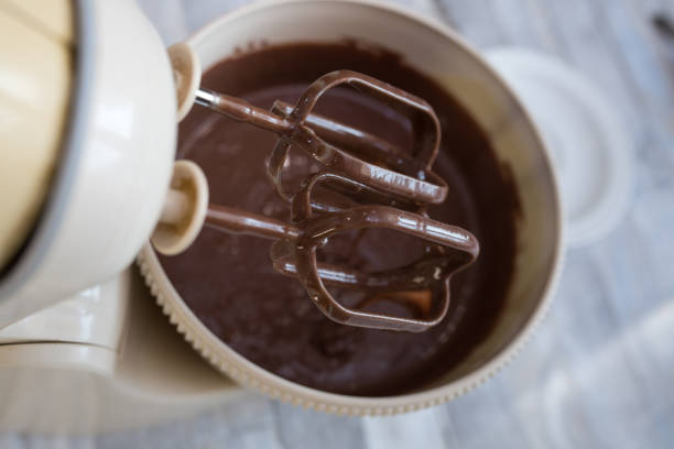 istock Cake making process. The dough is ready. The mixer beaters are stopped. Step by step recipe for chocolate cake. Series. Baking concept. 1339113415