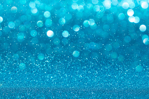 Defocused sparkling background in blue tones. Beautiful bokeh lights.