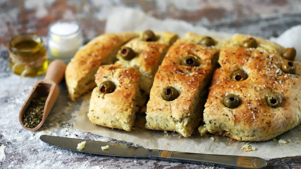 Traditional Italian bread with olives and spices. Focaccia. stock photo