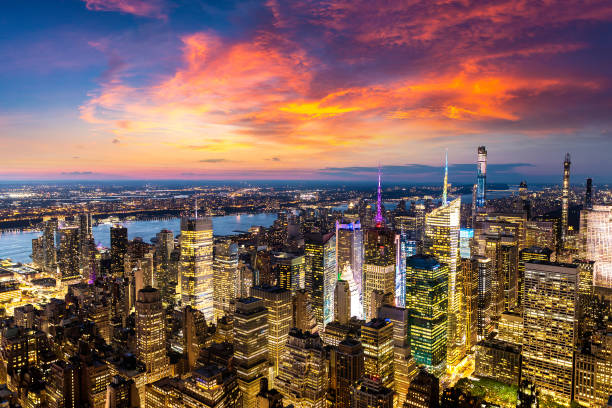 Aerial view of Manhattan at night Panoramic aerial view of Manhattan at sunset in New York City, NY, USA midtown manhattan stock pictures, royalty-free photos & images