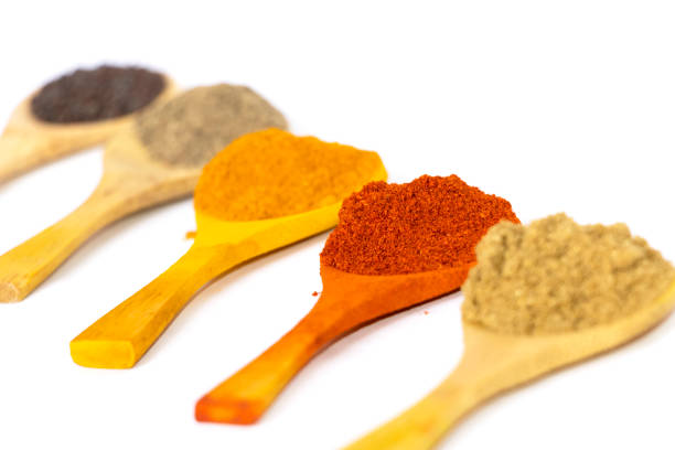 istock Indian Curry Powders In Wooden Spoon. White Background. Selective Focus 1339122091