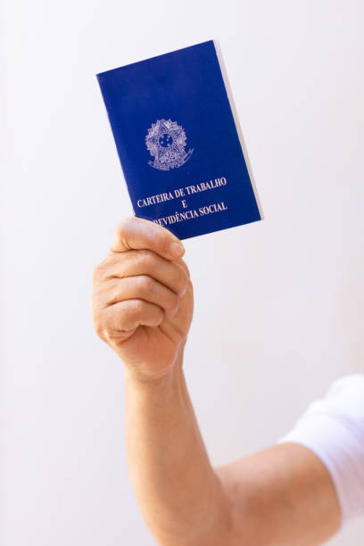 istock Holding a brazil work permit card, isolated on white background. Concept image. 1339122174