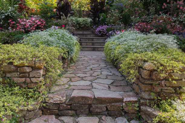 istock garden with flowers at both sides of the path 1339122369