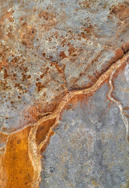 istock Dry rusty river bed over grey mine tailings, acid mine drainage texture 1339126815