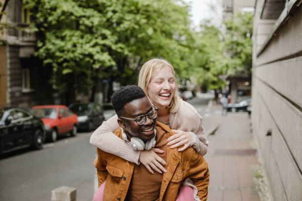 istock Cheerful young couple on the street 1339128233