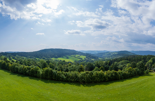 panoramic aerial view of beautiful Karkonosze (Krkonoše, Giant Mountains) mountains covered with green forest and meadows