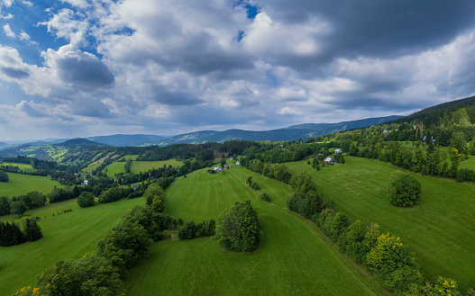 mountain landscape with grassy meadow. view in to the distant rural valley. sunny summer morning