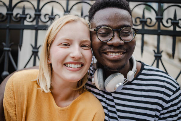 istock Diverse couple embracing on the street 1339129447