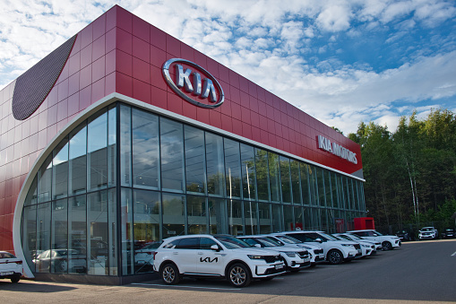 Moscow Region, Russia - September 2021: Building of KIA MOTORS car selling and service center outdoors. KIA logo and KIA MOTORS text on car showroom.