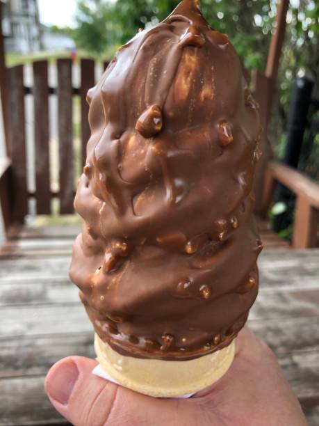 istock Ice cream cone dipped in hazelnut chocolate 1339135455