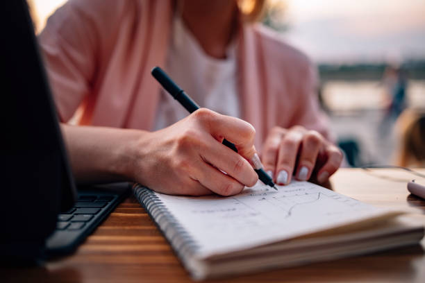 istock Unrecognizable Female Student Studying on Digital Tablet in a Cafe 1339141782