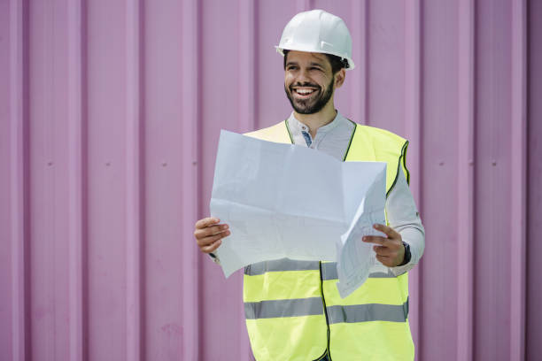 istock Portrait of a young civil engineer holding planning documents or technical drawing 1339142928