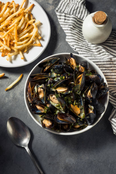 Homemade Moules Frites Mussels and Fries Homemade Moules Frites Mussels and Fries with a White Wine Sauce moules frites stock pictures, royalty-free photos & images