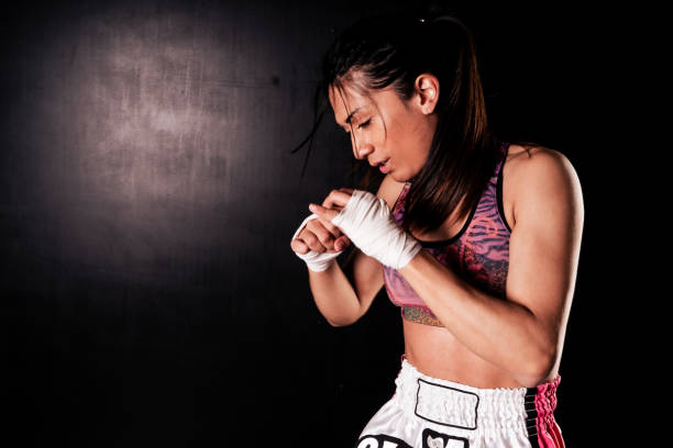 istock Beautiful woman practicing martial arts or boxing in defensive position against aggression. 1339144425