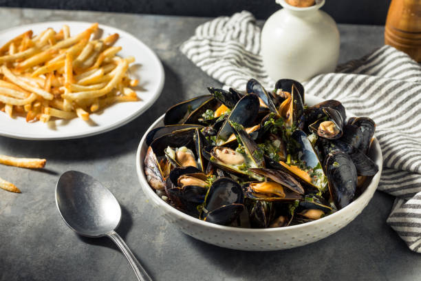 Homemade Moules Frites Mussels and Fries Homemade Moules Frites Mussels and Fries with a White Wine Sauce moules frites stock pictures, royalty-free photos & images