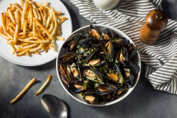 Homemade Moules Frites Mussels and Fries Homemade Moules Frites Mussels and Fries with a White Wine Sauce moules frites stock pictures, royalty-free photos & images