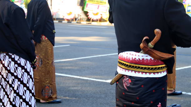 istock Men wearing traditional Javanese attire with keris 1339154782