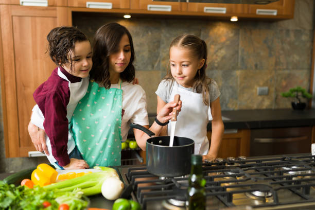 istock Beautiful family cooking dinner in the kitchen 1339155745