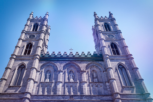 Low angle view of the colonial facade of the Notre-Dame Catholic Church in Old Montreal