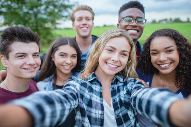 istock Happy and smiling teenagers taking a group selfie 1339161068