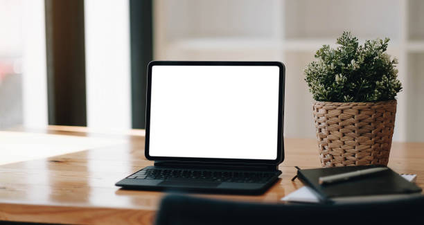 istock Laptop blank screen on wood table with coffee cafe background, mockup, template for your text, Clipping paths included for background and device screen 1339165837