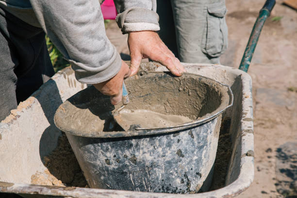 istock Kneading cement for pouring garden path, garden construction work 1339167202