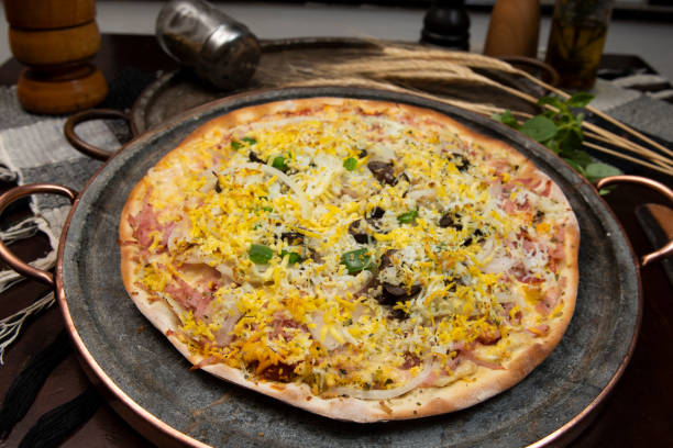istock Brazilian Portuguese-style pizza with ham, egg, pepper, onion, mozzarella 1339170420