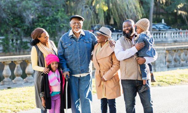istock Three generation African-American family standing in park 1339170472