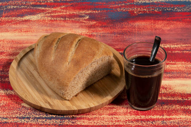 istock Piece of bread cut on a bamboo tray on a rustic table 1339170491