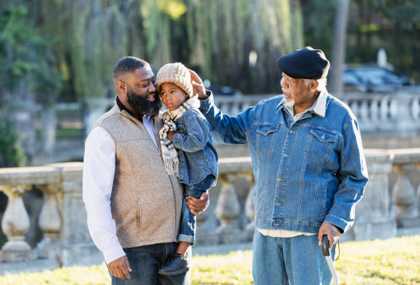 Three generation African-American family walking in park