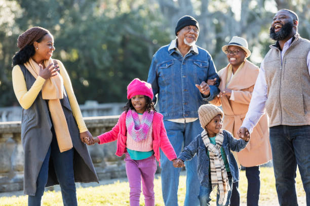 istock Three generation African-American family walking in park 1339170543