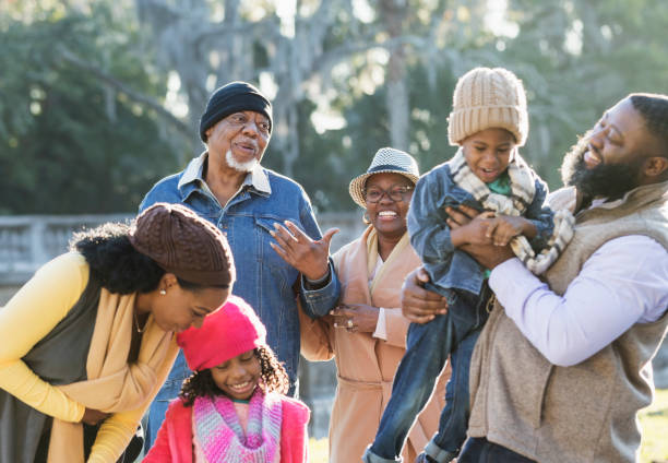 istock Three generation African-American family walking in park 1339170559
