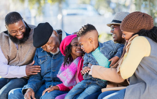 istock Three generation African-American family on park bench 1339170600