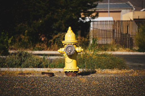 Old worn and aged yellow fire hydrant