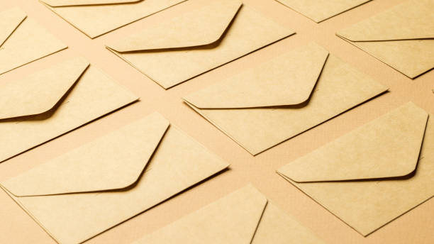 istock Background of closed paper envelopes on a paper background. 1339177350