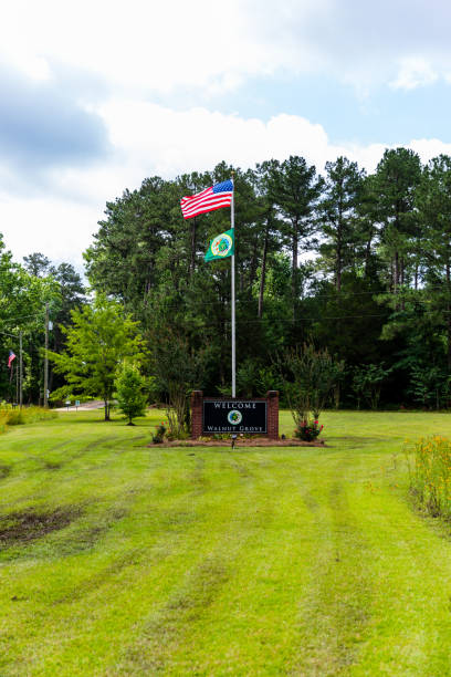 Welcome to Walnut Grove sign and flags in Walnut Grove, MS Walnut Grove, MS - June 9, 2021: Welcome to Walnut Grove sign and flags walnut grove stock pictures, royalty-free photos & images