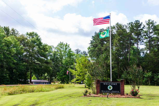Welcome to Walnut Grove sign and flags in Walnut Grove, MS Walnut Grove, MS - June 9, 2021: Welcome to Walnut Grove sign and flags walnut grove stock pictures, royalty-free photos & images