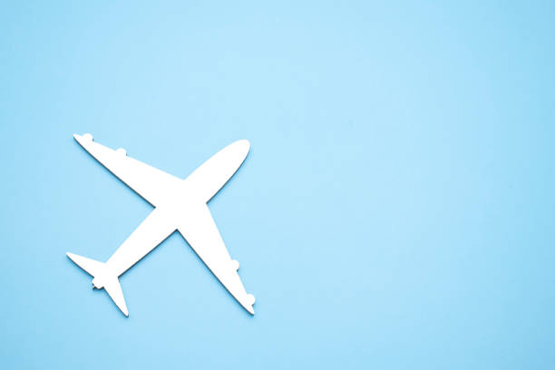 istock model of passenger plane on blue background 1339182403