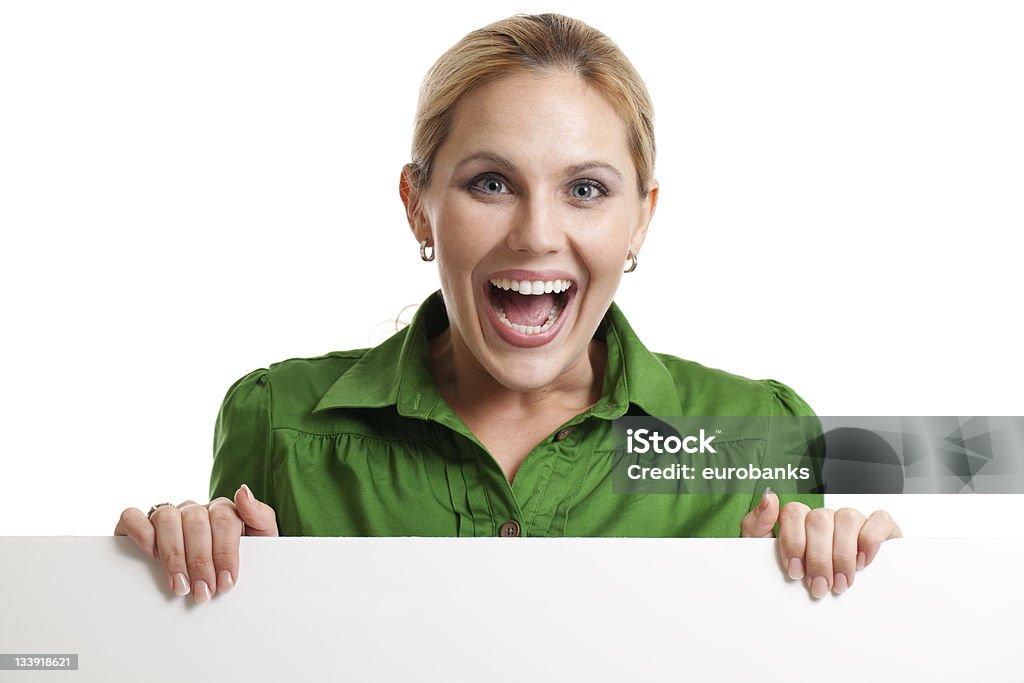 Excited woman holding a blank sign An excited woman holding a blank sign at the bottom isolated on white. 30-34 Years Stock Photo