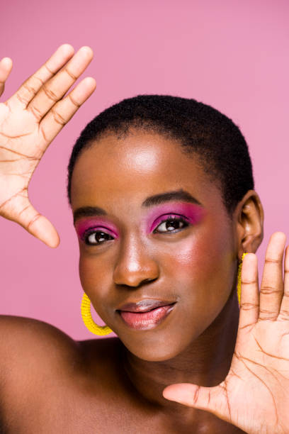 istock Young woman with dewey make up look frames face with hands 1339187070