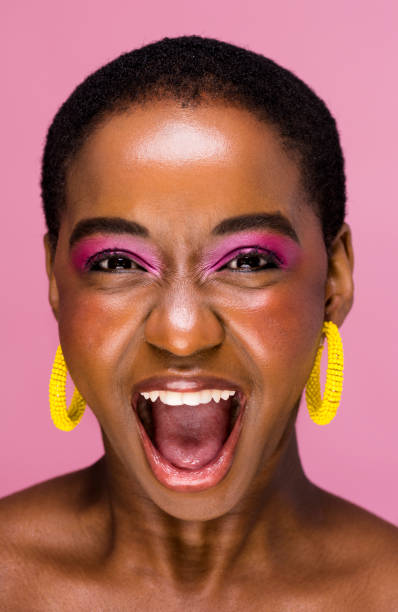 istock Young African woman with bright makeup shouting in excitement 1339187071